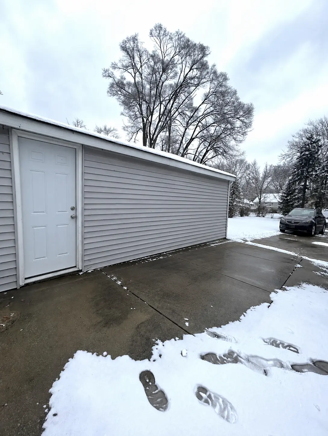 The same driveway and garage area completely cleared after removal
