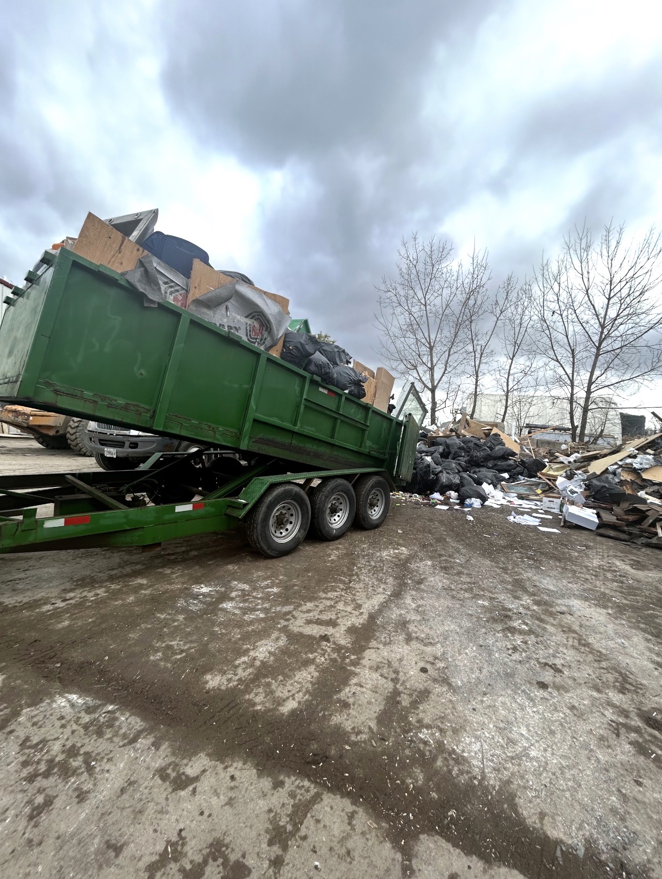 Rigor Contracting trailer unloading debris at the transfer station